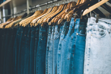 Jeans hanging on a rack in a store. Copy space