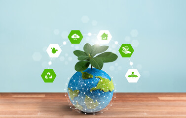 Eco world and green Earth day concept, Earth globe with young tree planted on top and eco-friendly...