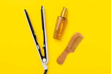 Hair straightener with thermo protection on color background, top, view