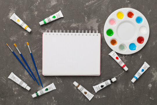 Painting tools on concrete background, top, view