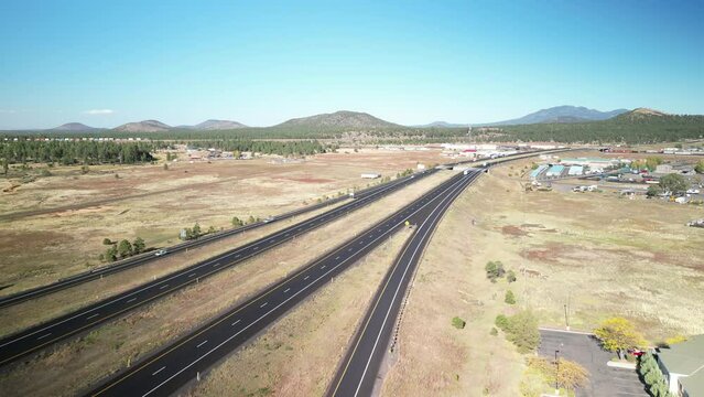Aerial above Interstate 40 through town of Williams Arizona on autumn day