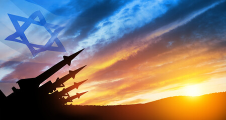 The missiles are aimed at the sky at sunset with Israel flag. Nuclear bomb, chemical weapons, missile defense.