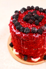 Red velvet cake, cream sponge cake with soaked filling decorated with pomegranate seeds and berries, top view, isolated on a white background