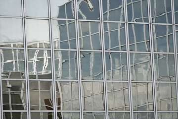 shop windows of a large office building with a reflection . - 669303772