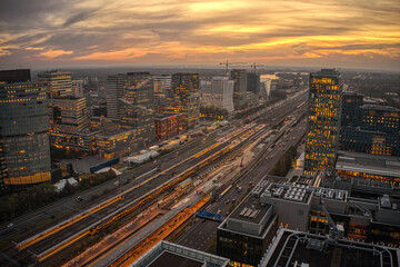 Fototapeta na wymiar Aerial View of the Business District of Amsterdam along the Train Station at Sunset