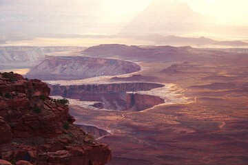The rays of the setting sun illuminated into  gold the path along the Rim Trail in Canyonlands, Utah, USA.