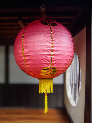 A red lantern with a yellow tassel hanging from the ceiling.
