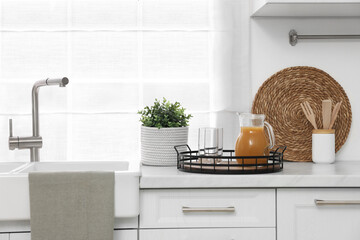 Beautiful potted artificial plant on countertop in kitchen. Home decor