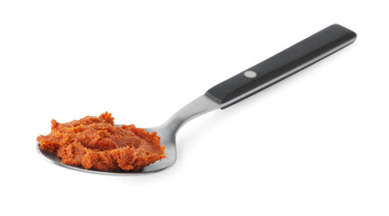 Tasty curry paste in spoon isolated on white