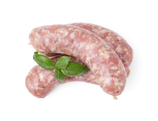 Raw homemade sausages and basil leaves isolated on white, top view