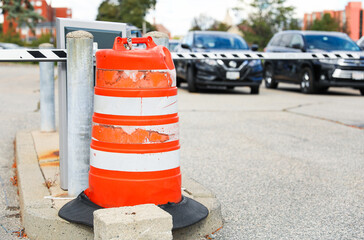 construction cone, standing alone on a sunlit urban street, symbolizing safety, roadwork, caution,...