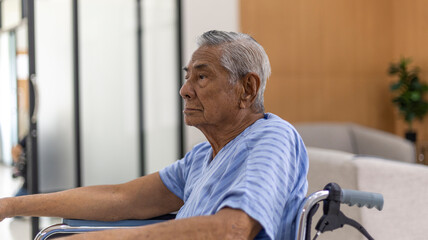 Old man sitting on a wheelchair in a health care office with happy face