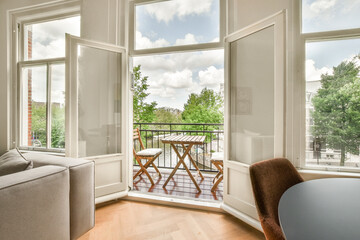 a living room with two windows and a table on the floor in front of the window looking out onto the...