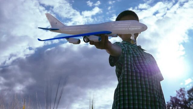 Skyward Dreams: Boy Playing with Toy Plane, Aspiring to Be a Pilot in the Evening