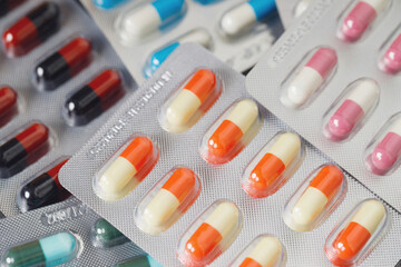 close up pharmaceuticals antibiotics pills medicine in blister packs. colorful antibacterials pills...