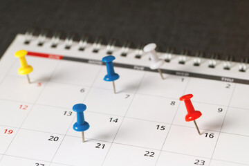 mark the event day with a pin. Thumbtack in calendar concept for busy timeline organize...