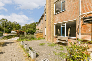 an outside area with some plants and bushes in the fore - eyed view, as seen from another side window