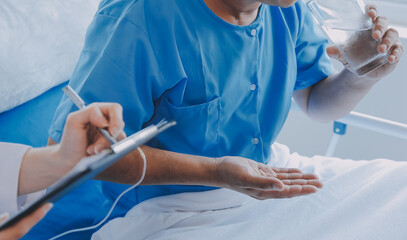 Women Asian doctors hold the patient hand and encourage and provide medical advice While checking...