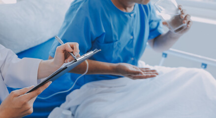 Women Asian doctors hold the patient hand and encourage and provide medical advice While checking...