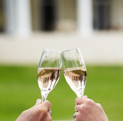 Couple, married and hands with champagne in celebration of anniversary, success or retirement. Mature, man and woman with toast, drink or cheers at hotel for love, romance or quality time in bond