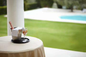 Hospitality, outdoor and hotel with champagne, glass and pool view for luxury, accommodation and...