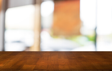 Mock up for space. Empty dark wooden table in front of abstract blurred bokeh background of restaurant . can be used for display or montage your product