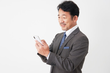 スマートフォンを使う中年のビジネスマン　白背景