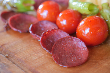  smoked salami sausage and tomato meal on table 