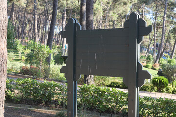  wooden sign in the a park with copy space concept.