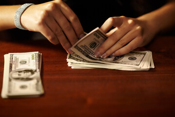 Woman, hand and count dollar cash for rich winning, deal or secret wealth fraud. Female person,...