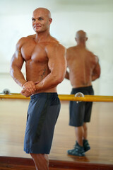 Obraz premium Man, strong arm and flex in mirror at gym with fitness, workout and exercise of bodybuilder with reflection. Muscle, person and athlete with sport training, wellness and body builder at a health club