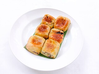 Banana choco. bread that has a crispy layer of skin. Banana balls. A group of cake with banana and chocolate filling on plate against white background. Close up