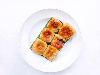 banana choco. bread that has a crispy layer of skin. Banana balls. A group of Cake with banana and chocolate filling in plate on white  background