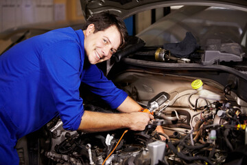 Fototapeta na wymiar Portrait, smile and car with a mechanic man in a workshop as an engineer looking at the engine of a vehicle. Garage, service or repair with a happy technician working under the hood of an automobile
