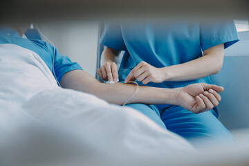 Women Asian doctors hold the patient hand and encourage and provide medical advice While checking the patient health in bed. Concept of Care and compassion, antenatal care, Threatened abortion - obrazy, fototapety, plakaty