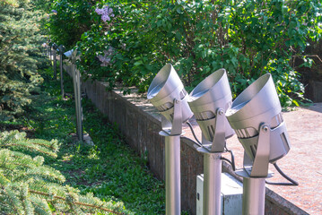 Street lamps for lighting at night. Electric lights in the city park for street lighting. Street lighting in the city. Illumination for decoration and illumination of objects of trees in the park.