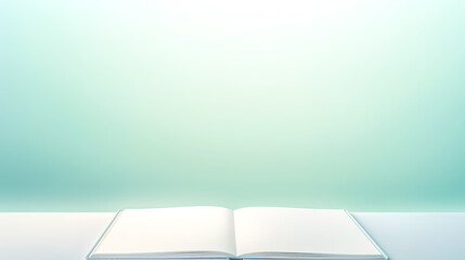 Open blank book on a light green background.