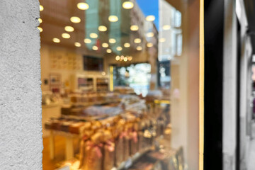 Blurry cafe and sweets shop window with street reflections