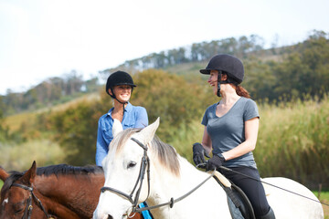 Women friends, horse riding and talk with smile in helmet, ranger team and equestrian exercise. Girl outdoor together, jockey and chat on adventure, training or learning for contest in countryside
