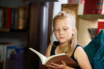 Girl, kid and library for reading book, education and learning of language, literature and fiction...