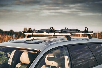 Versatile Roof Rack for Station Wagons: Safely Transporting Sports Equipment and Big Items. A roof rack or bar on a station wagon or estate car. Transportation of sports equipment in the family car.