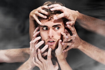 Scared, schizophrenia and man with hands, mental health or bipolar in studio isolated on a black background. Face, smoke and person with fear, horror or abuse drugs, hallucination and sick fantasy - obrazy, fototapety, plakaty