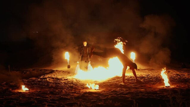 Amazing Fire Show In Night On Sandy Beach Or In Desert, Acrobats Stuntmen Performing Circus Trick