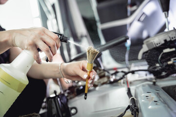 Worker make dry cleaning the car interior using a special brush with foam