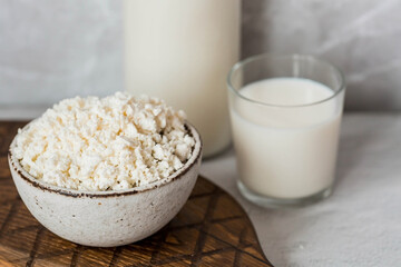 Fresh dairy products, milk, cottage cheese, eggs in stylish ceramic dishes on a gray background. The concept of natural, dietary nutrition. Useful products.