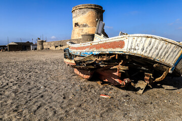 Abandoned fishing boat on the beach in Spain