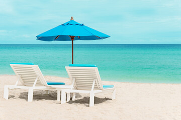 Beautiful blue sun loungers on the shore of a paradise island