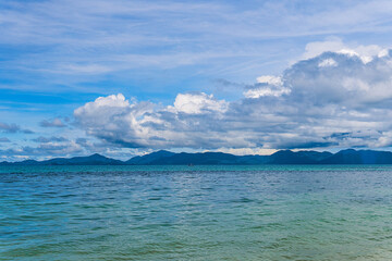 A beautiful shot of sea with a mountain in the distance and a clear sky