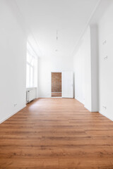 Empty room with wooden floor in new flat after renovation