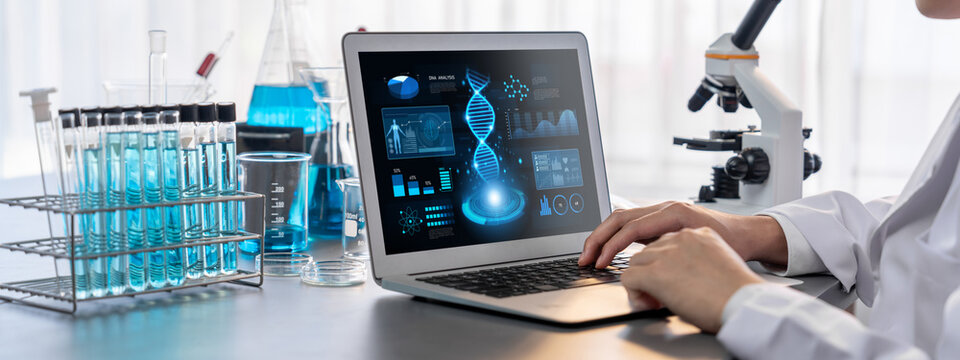 Scientist working on advance biotechnology computer software to study or analyze DNA data after making scientific breakthrough from chemical experiment on medical laboratory. Neoteric